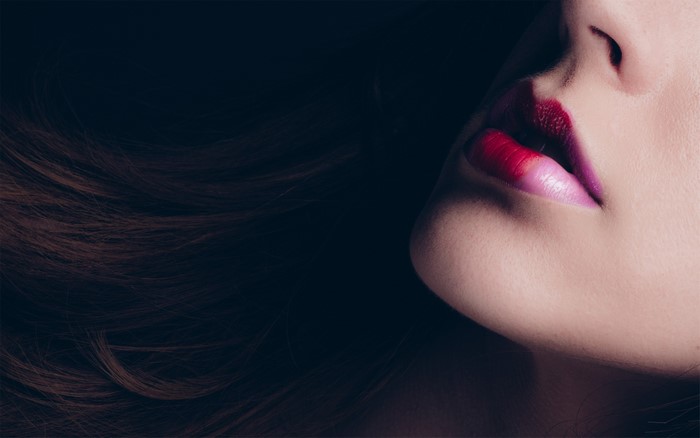 Close-up of woman's lips with ombre lipstick
