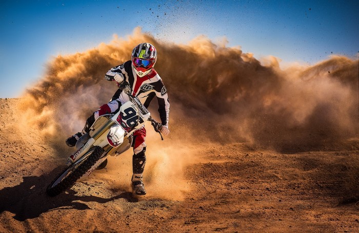 Motorcycle Rider Kicking Up Dust in Race