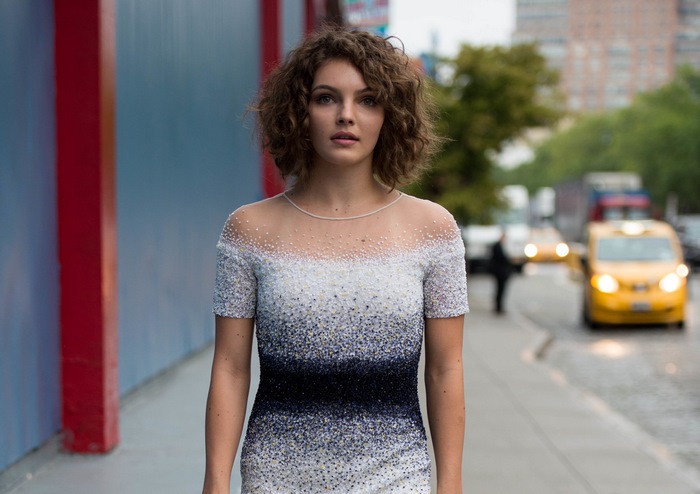 Camren Bicondova in a beaded dress on a city street