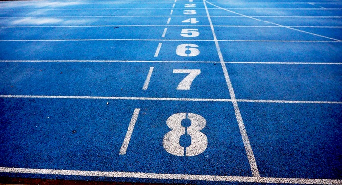 Blue running track with lane numbers