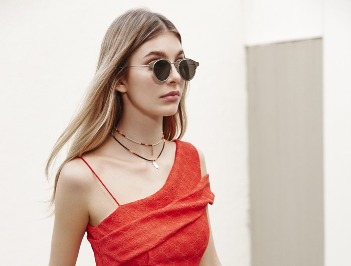 Camila Morrone wearing sunglasses and a red dress
