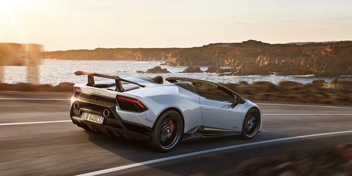 White Lamborghini Huracan Performante Spyder driving on coastal road