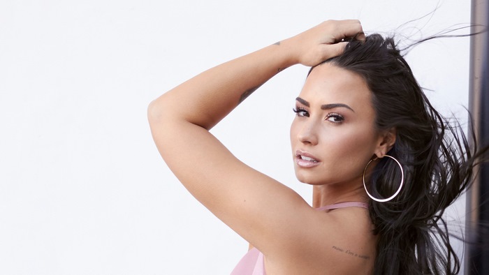 Demi Lovato posing with hand in hair
