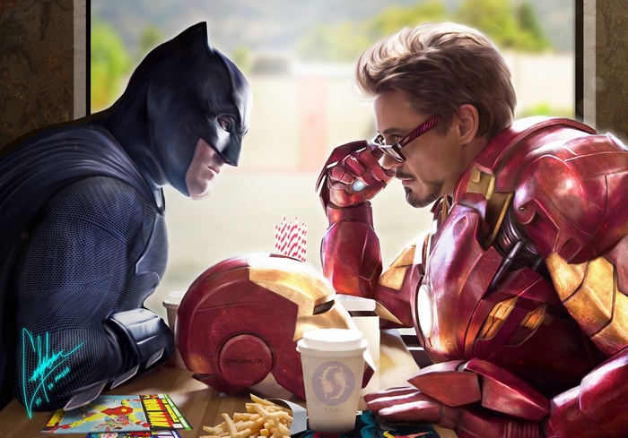 Batman and Iron Man at a table with food