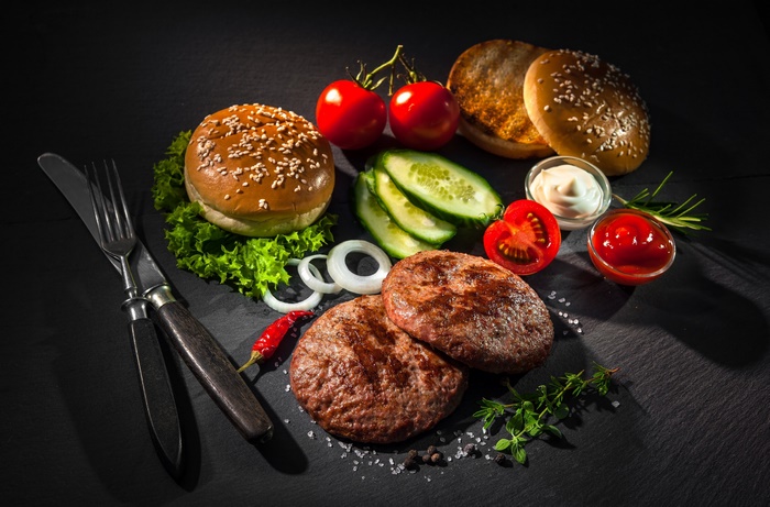 Fresh Homemade Burger Ingredients with Patties and Vegetables
