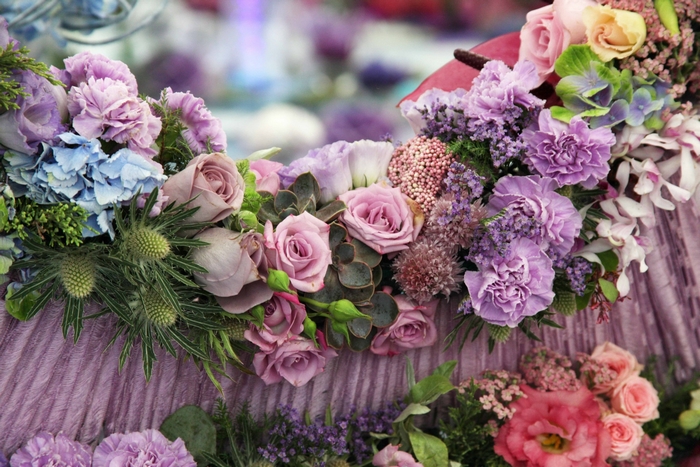 Floral arrangement with roses, hydrangeas, and thistles