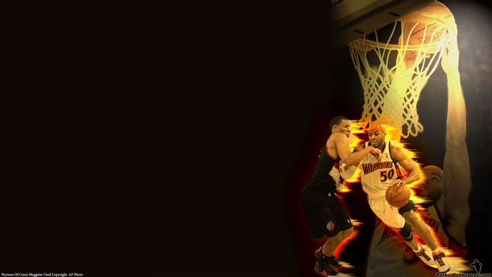 Basketball players in action near a hoop