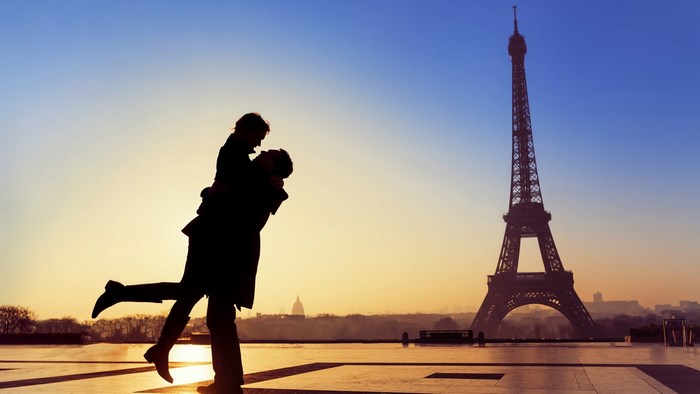 Couple embracing in front of the Eiffel Tower, Paris