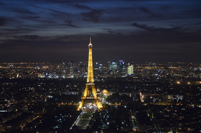 Eiffel Tower illuminated at night over Paris cityscape