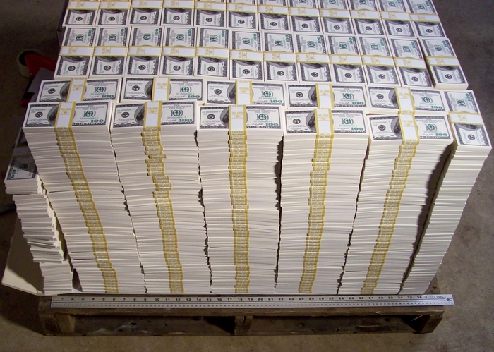 Stacks of fake $100 bills on a pallet