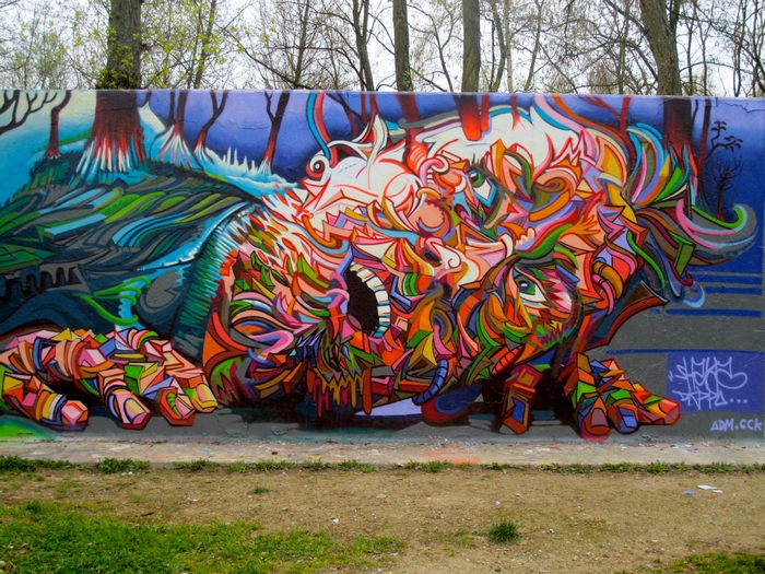 Graffiti mural with abstract figures and forest scene
