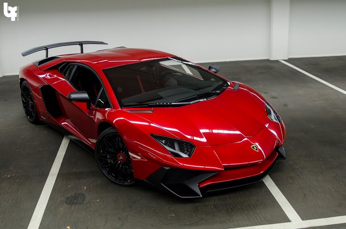 Red Lamborghini Aventador parked in a garage