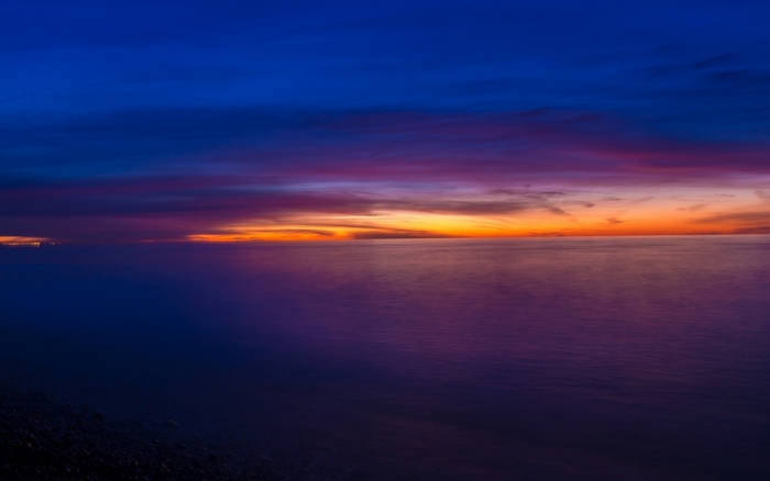 Sunset over the ocean with colorful clouds