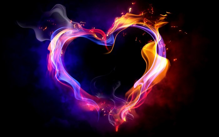 Heart shape made of colorful fire and smoke