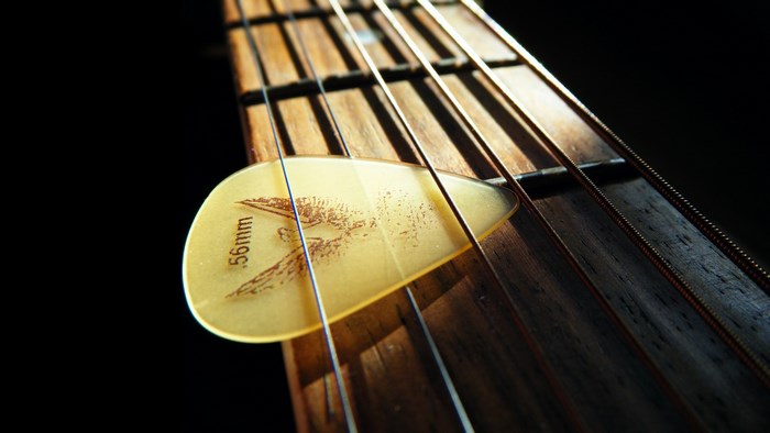 Guitar pick on guitar strings