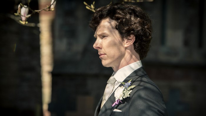 Sherlock Holmes in a suit with a boutonniere