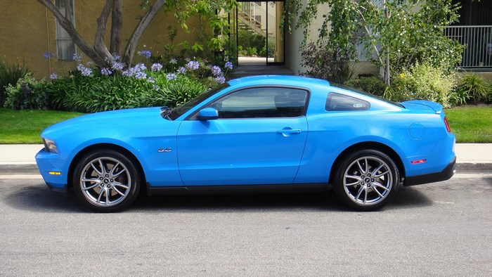 Blue Ford Mustang parked on a street