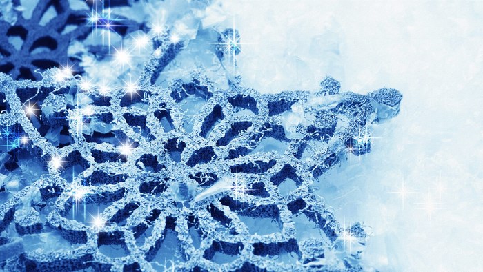 Close-up of a blue snowflake with sparkles
