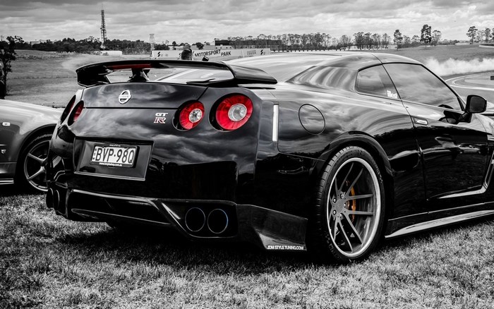 Black Nissan GT-R on a grassy field