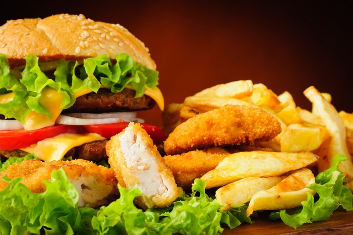 Burger, chicken nuggets, and french fries on lettuce