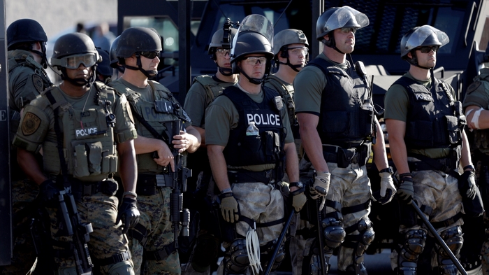 Police officers in tactical gear standing together