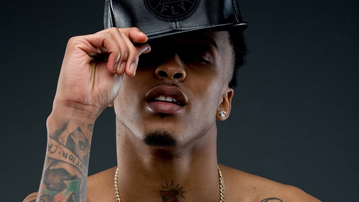 August Alsina wearing a black cap