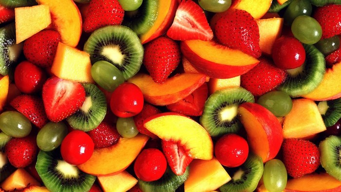 Assortment of Fresh Fruits: Strawberries, Kiwi, Peaches, and Grapes