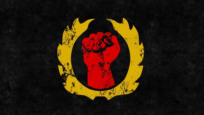 Red fist symbol with yellow flames on black background