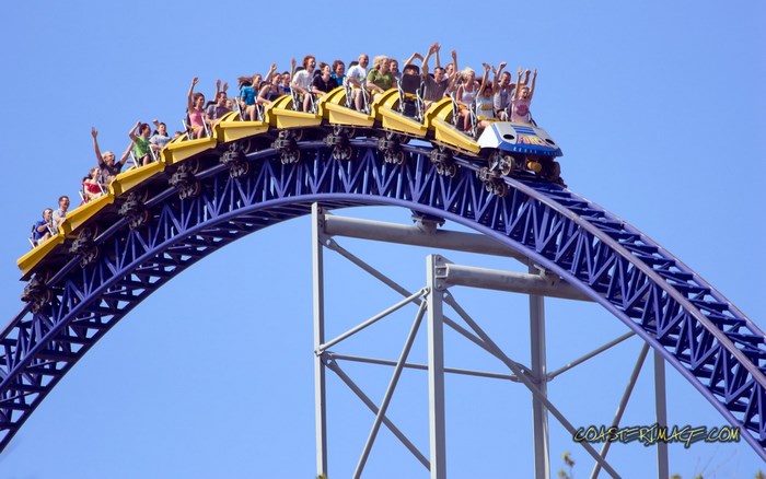 People on a yellow roller coaster on a blue track