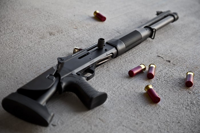 Benelli shotgun with shells on concrete