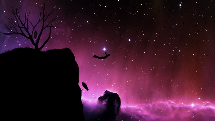 Silhouette of a person reaching for a star in space