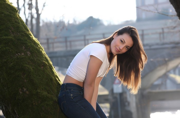 Lorena Garcia leaning on a tree