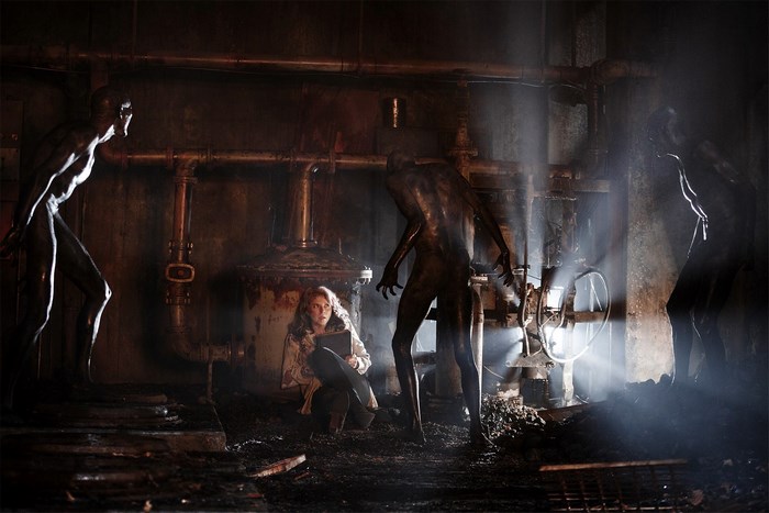 Girl and creatures in industrial setting