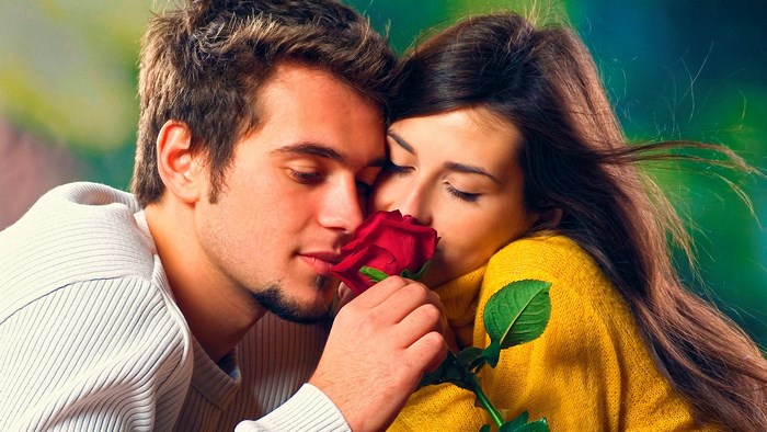 Couple smelling a red rose
