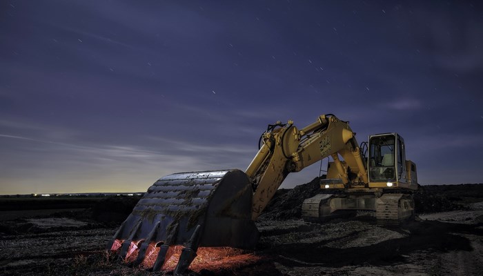 Excavator at Work Under a Starry Night Sky