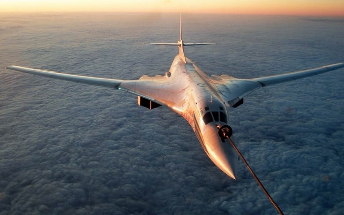 Tupolev Tu-160 bomber flying above clouds