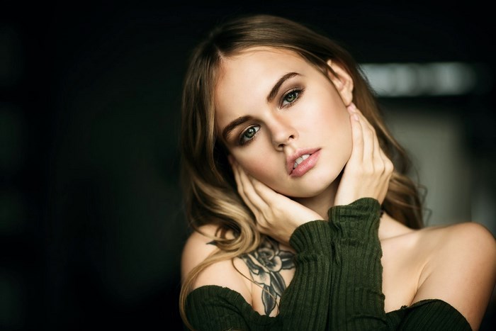 Portrait of a Young Woman with Tattoo and Green Sweater