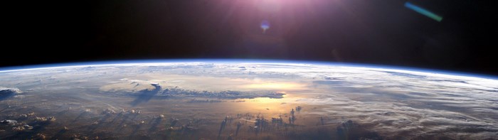 Earth from space with sun glare