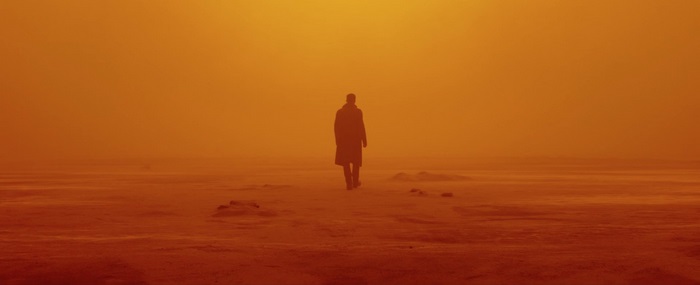 Man walking in orange fog from Blade Runner 2049