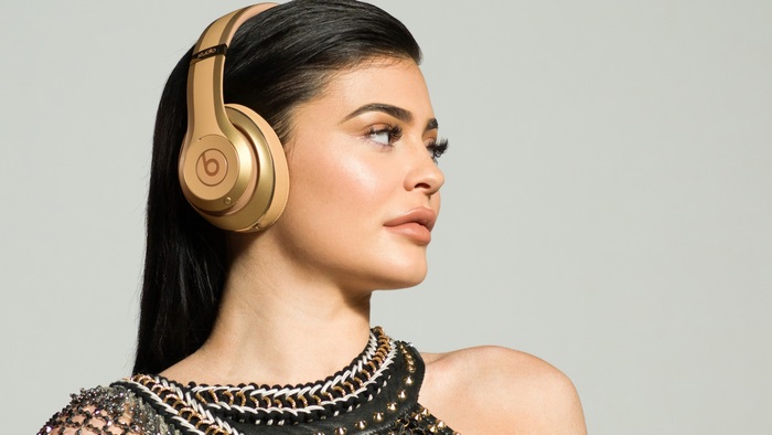 Kylie Jenner wearing gold Beats headphones
