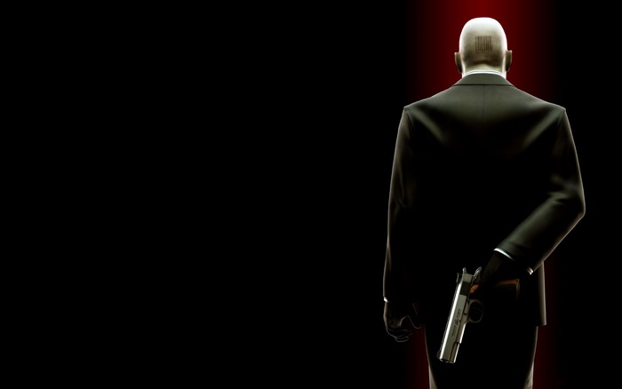 Agent 47 from Hitman holding a gun