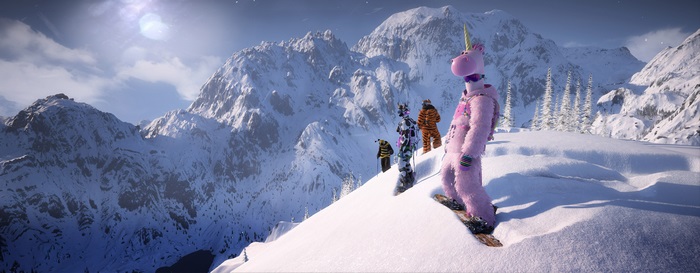 People in costumes snowboarding on a snowy mountain