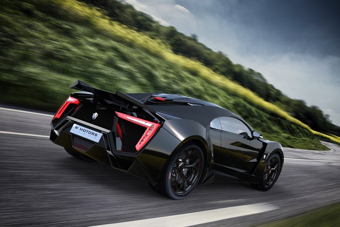 Black Lykan Hypersport driving on a winding road