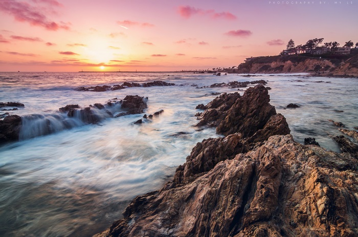Sunset over Corona Del Mar rocky coast 4K