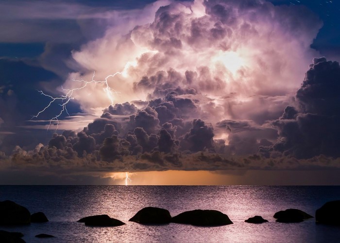 Lightning strikes over the sea during a storm