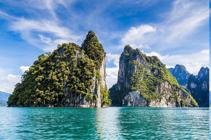 Limestone islands in turquoise water under a cloudy sky