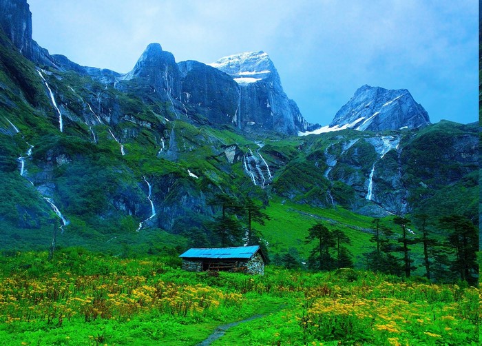 Mountain valley with waterfalls and a hut