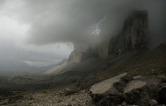 Lightning strikes over a stormy mountain landscape in the Alps