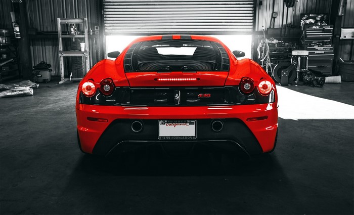 Red Ferrari F430 Scuderia in a garage