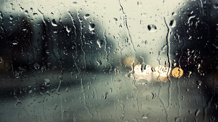 Raindrops on glass with bokeh lights